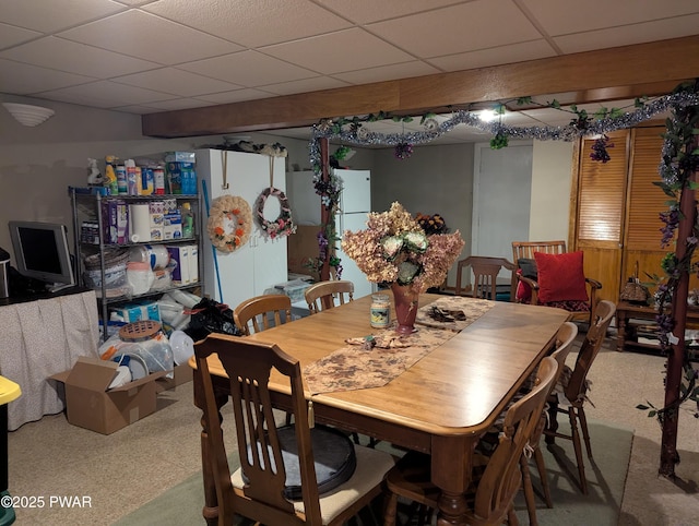 dining room with carpet floors and a drop ceiling