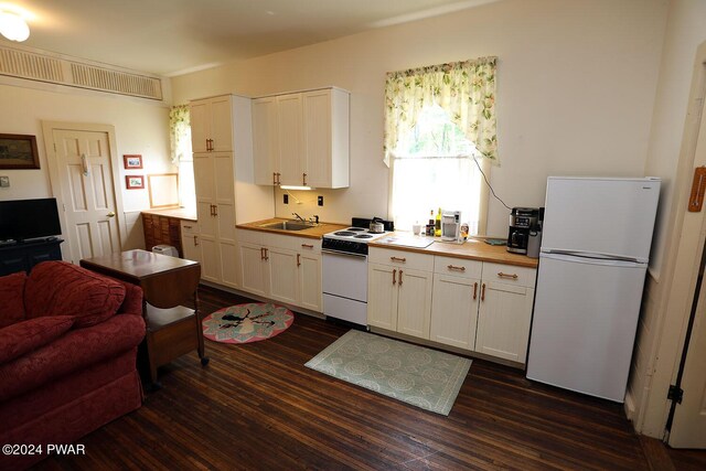 kitchen featuring dark hardwood / wood-style flooring, white cabinets, white appliances, and sink