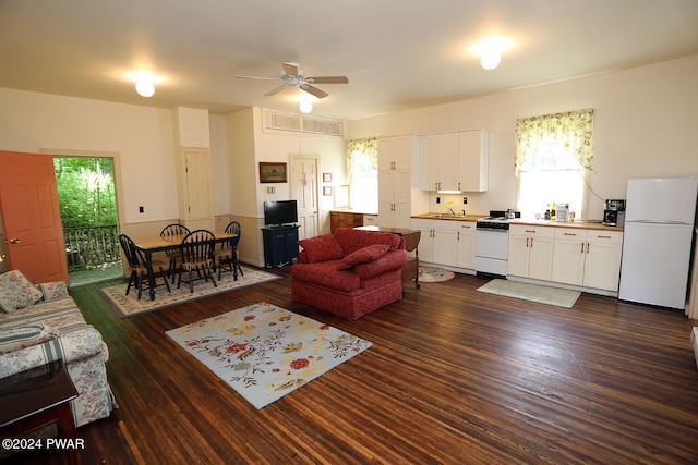 living room featuring ceiling fan, dark wood-type flooring, and sink