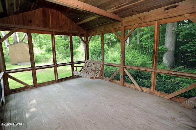 unfurnished sunroom with lofted ceiling with beams