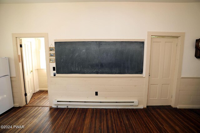 details with hardwood / wood-style flooring, a baseboard radiator, and white refrigerator