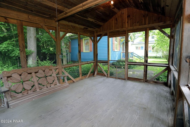 unfurnished sunroom with lofted ceiling