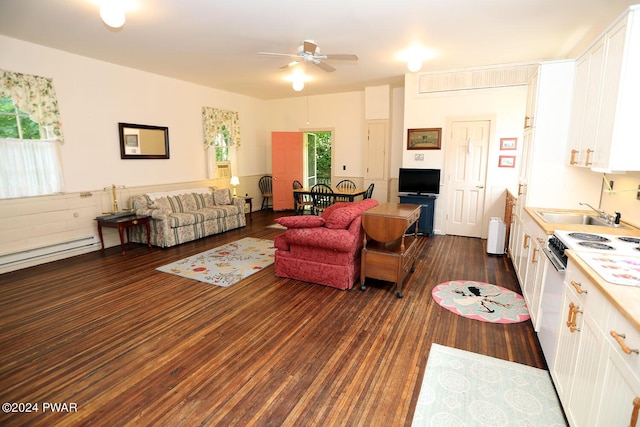 living room with ceiling fan, dark hardwood / wood-style flooring, plenty of natural light, and sink