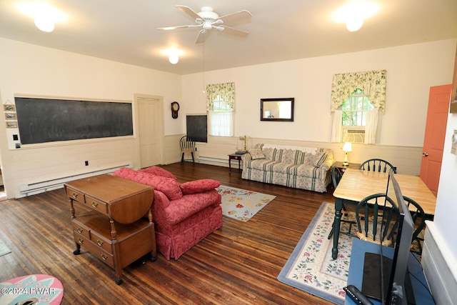 living room with ceiling fan, dark hardwood / wood-style flooring, and a baseboard heating unit