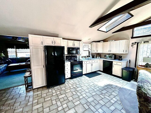 dining space with beam ceiling, a skylight, high vaulted ceiling, and ceiling fan