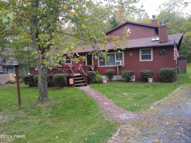 view of front of property featuring a wooden deck, cooling unit, and a front yard