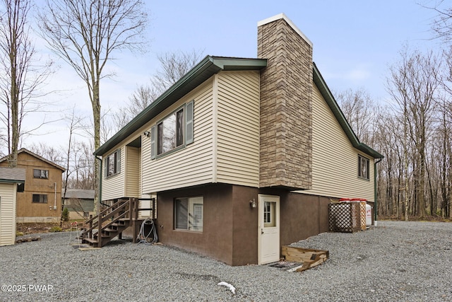 104 Rockway Rd, Lake Ariel, PA 18436 - rear view of house featuring stairway and a chimney
