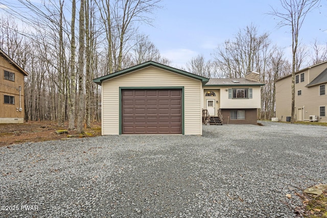 104 Rockway Rd, Lake Ariel, PA 18436 - view of front of house featuring driveway, a chimney, a detached garage, cooling unit, and entry steps