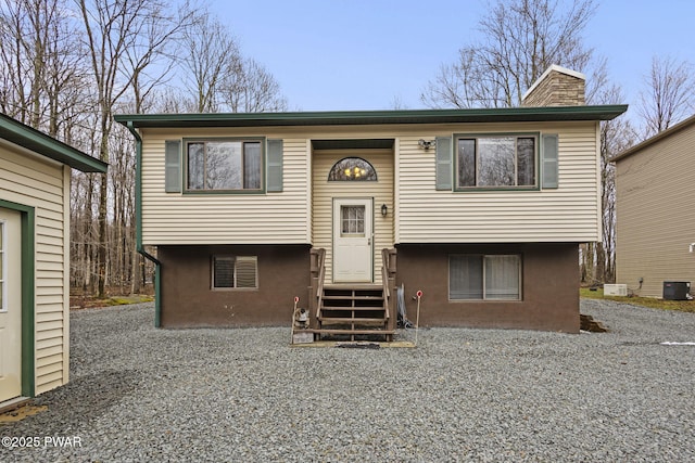 104 Rockway Rd, Lake Ariel, PA 18436 - bi-level home with central AC, a chimney, entry steps, and stucco siding