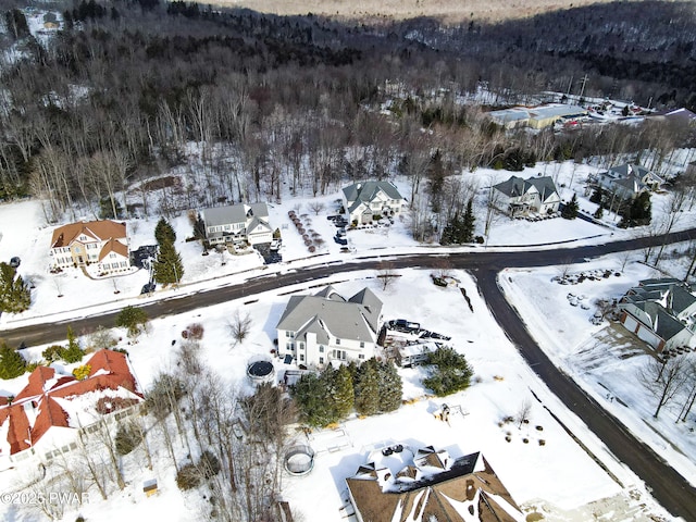 snowy aerial view with a residential view