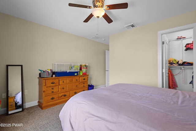 carpeted bedroom featuring a closet, visible vents, a spacious closet, ceiling fan, and baseboards