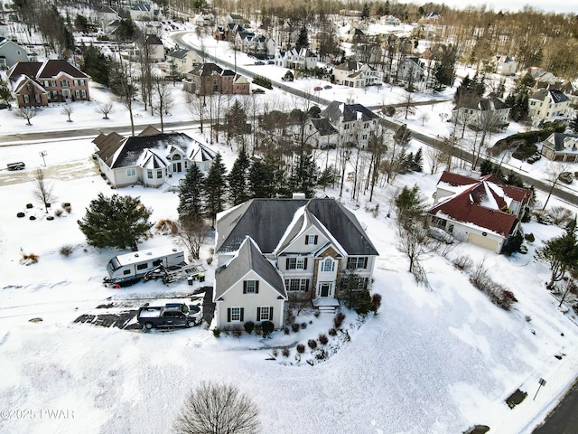 snowy aerial view with a residential view