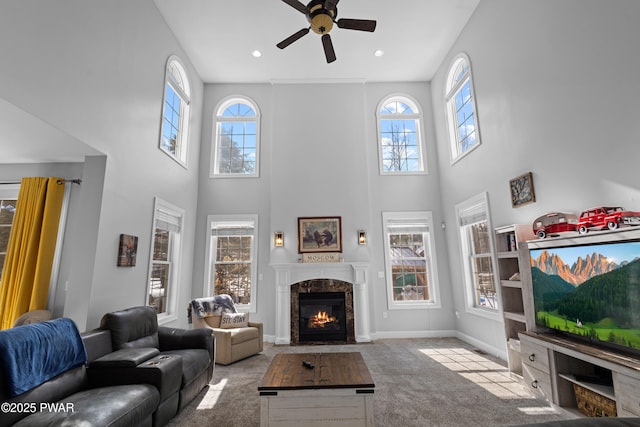 living area featuring plenty of natural light, carpet, and a premium fireplace