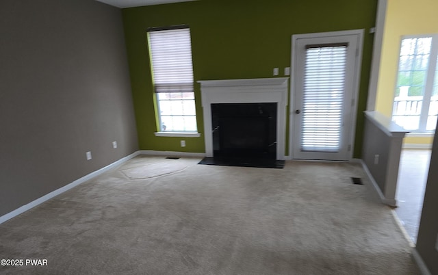 1712 Big Ridge Dr, East Stroudsburg, PA 18302 - unfurnished living room featuring carpet floors, baseboards, and a healthy amount of sunlight
