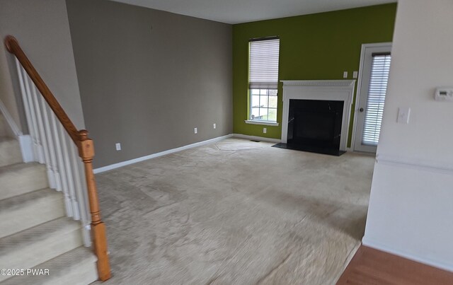 1712 Big Ridge Dr, East Stroudsburg, PA 18302 - unfurnished living room featuring carpet floors, stairs, baseboards, and a fireplace