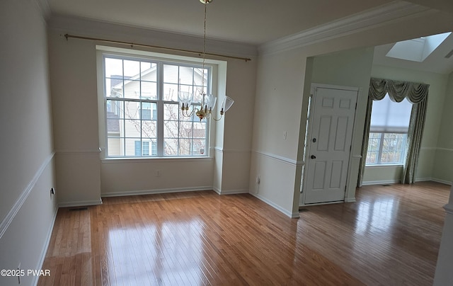 1712 Big Ridge Dr, East Stroudsburg, PA 18302 - unfurnished dining area with plenty of natural light, ornamental molding, wood finished floors, and an inviting chandelier