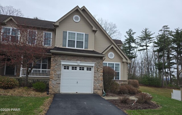 1712 Big Ridge Dr, East Stroudsburg, PA 18302 - view of front facade featuring an attached garage, stone siding, and aphalt driveway