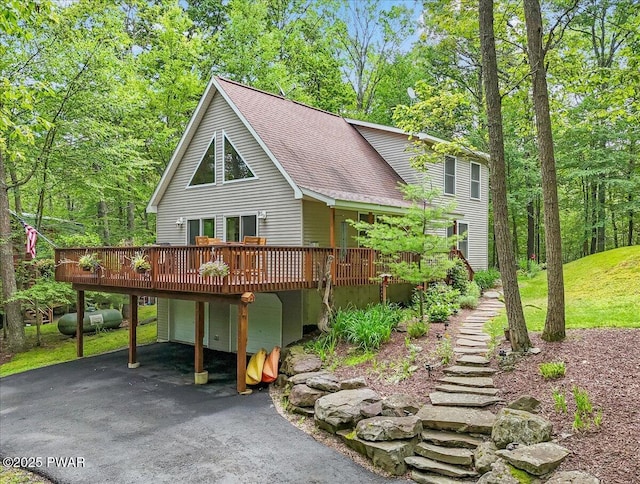 111 Sun Valley Dr, Tafton, PA 18464 - view of front of property featuring roof with shingles, a wooden deck, a garage, driveway, and a carport