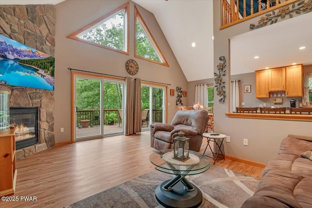 111 Sun Valley Dr, Tafton, PA 18464 - living room with high vaulted ceiling, light wood finished floors, healthy amount of natural light, and a stone fireplace