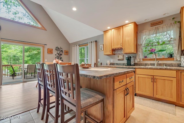 111 Sun Valley Dr, Tafton, PA 18464 - kitchen featuring light tile patterned floors, high vaulted ceiling, a breakfast bar, recessed lighting, and a kitchen island