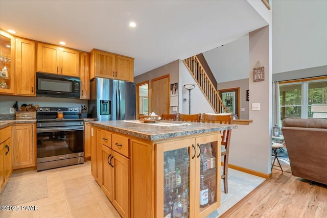 111 Sun Valley Dr, Tafton, PA 18464 - kitchen with stainless steel appliances, glass insert cabinets, a center island, and recessed lighting
