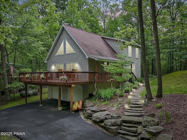 111 Sun Valley Dr, Tafton, PA 18464 - view of front of home with a wooden deck, driveway, a shingled roof, and an attached garage