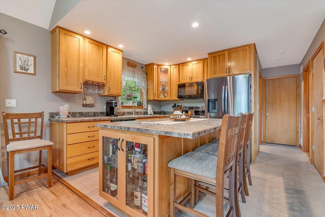 111 Sun Valley Dr, Tafton, PA 18464 - kitchen with black microwave, stainless steel fridge, a kitchen breakfast bar, recessed lighting, and a kitchen island
