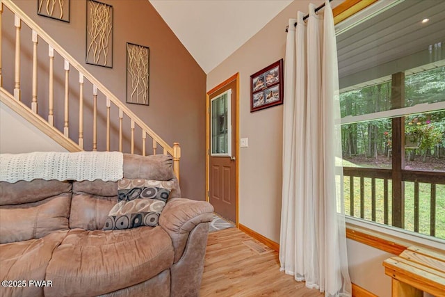 111 Sun Valley Dr, Tafton, PA 18464 - living room with lofted ceiling, wood finished floors, and stairs