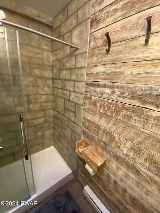 bathroom with baseboard heating and an enclosed shower