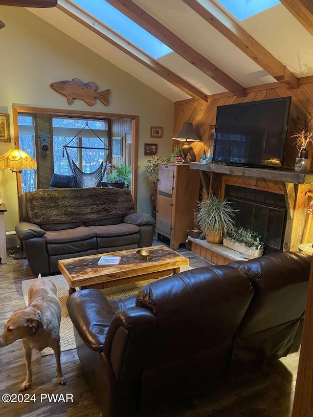 living room featuring beamed ceiling, wood walls, and hardwood / wood-style flooring