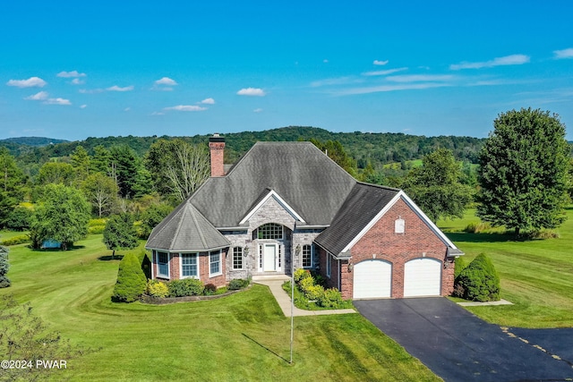 view of front of property with a garage and a front lawn