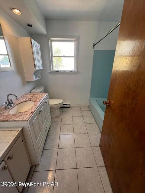 bathroom featuring tile patterned flooring, vanity, and toilet