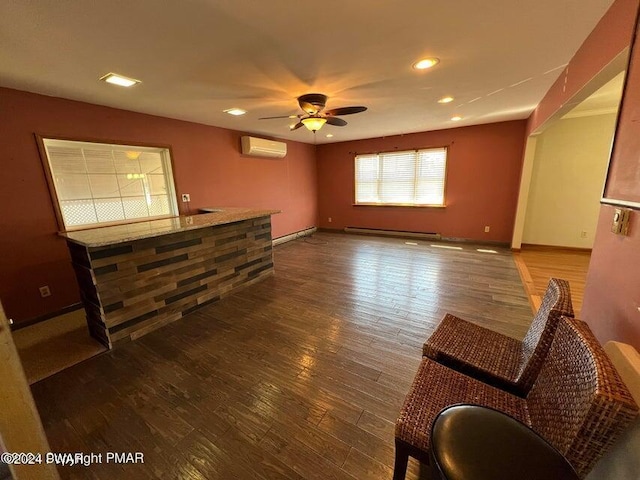 living room featuring a wall unit AC, ceiling fan, dark hardwood / wood-style flooring, and a baseboard radiator