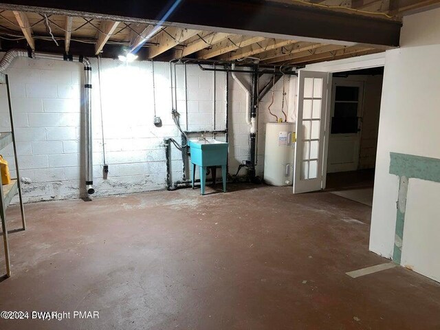 basement featuring sink and water heater