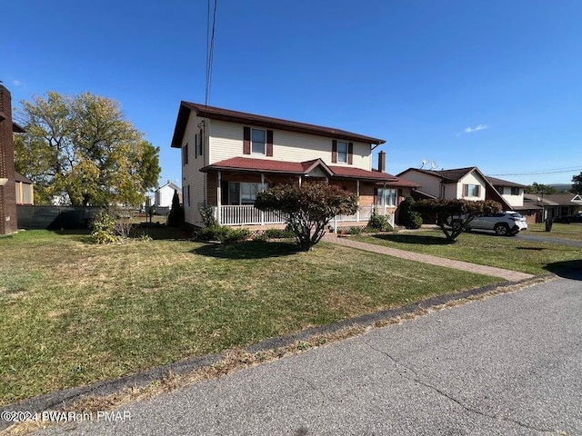 front of property with covered porch and a front yard