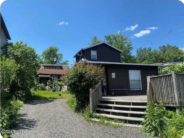 rear view of house with a wooden deck