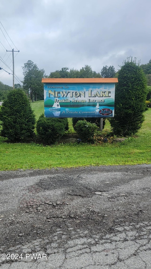 community / neighborhood sign with a lawn