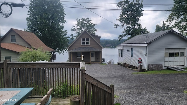 back of property featuring an outbuilding