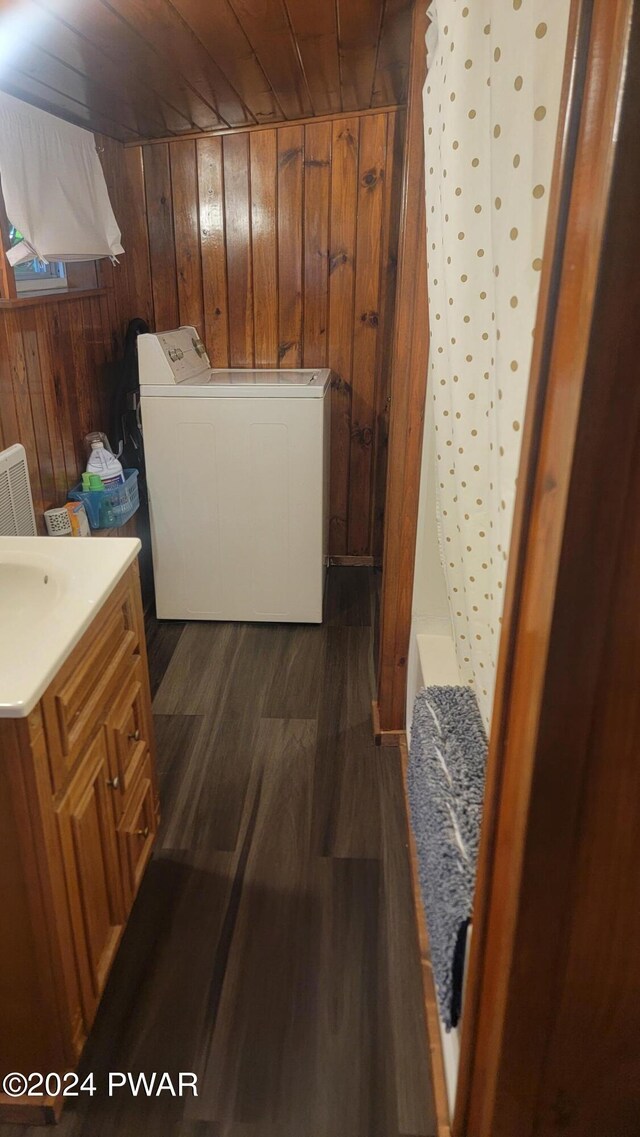 laundry area with washer / clothes dryer, wood walls, dark wood-type flooring, and wooden ceiling