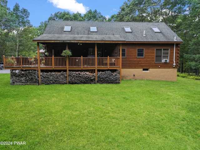 rear view of property featuring a lawn