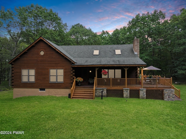 cabin featuring a yard and a deck