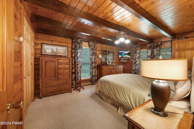 carpeted bedroom with wood walls, a notable chandelier, beam ceiling, and wooden ceiling