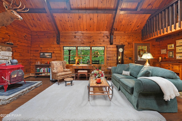 living room featuring a wood stove, wood walls, beamed ceiling, and wooden ceiling