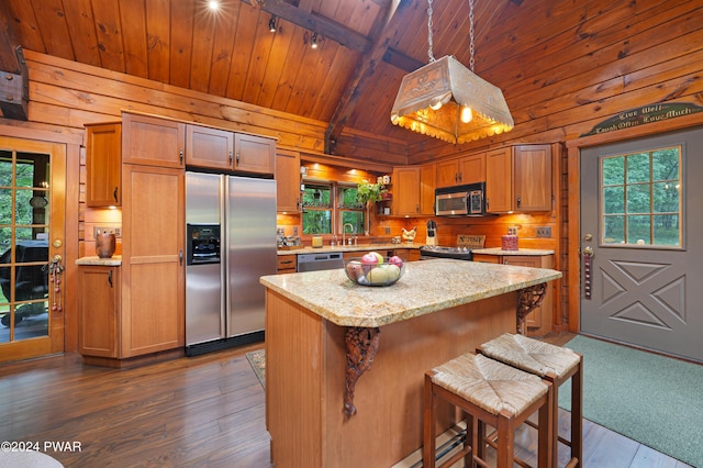 kitchen featuring a center island, hanging light fixtures, dark hardwood / wood-style flooring, wood ceiling, and appliances with stainless steel finishes