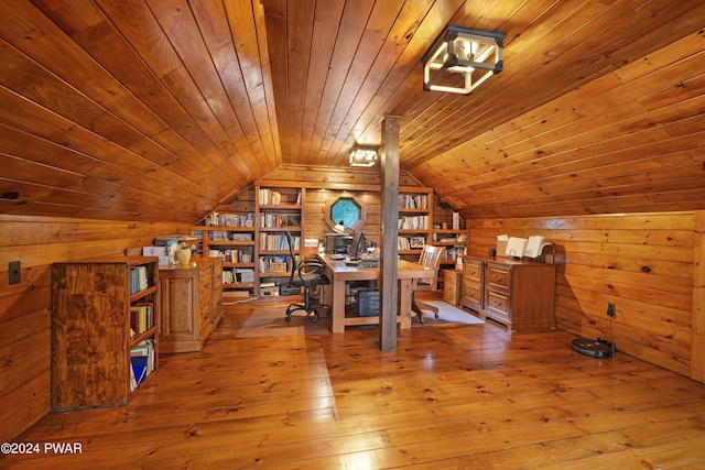 unfurnished office featuring light wood-type flooring, vaulted ceiling, wooden walls, built in features, and wooden ceiling