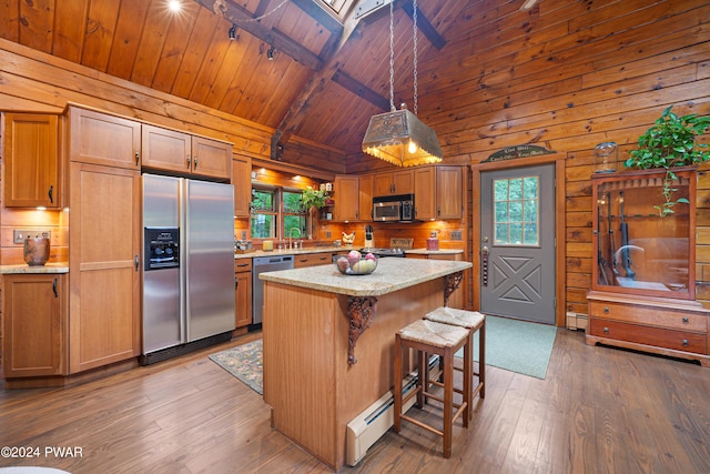 kitchen featuring pendant lighting, a center island, beamed ceiling, wood ceiling, and stainless steel appliances