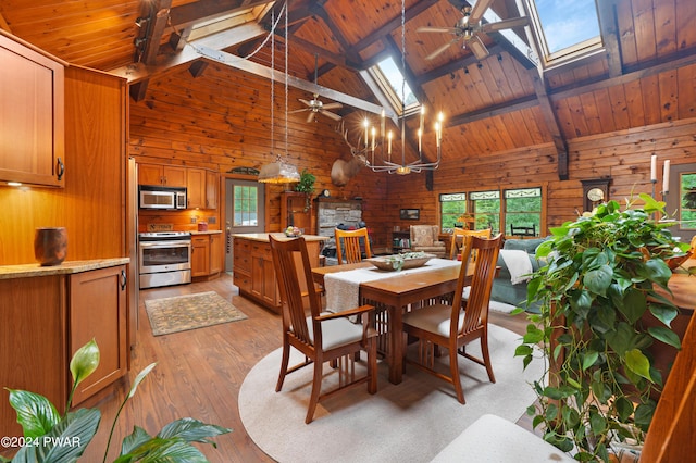 dining area featuring beamed ceiling, wooden ceiling, and a skylight