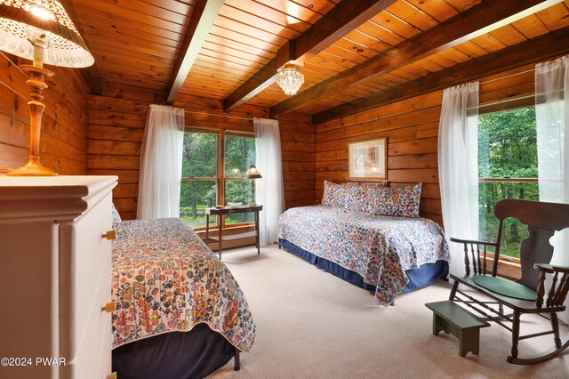 bedroom featuring wood walls, beam ceiling, and multiple windows