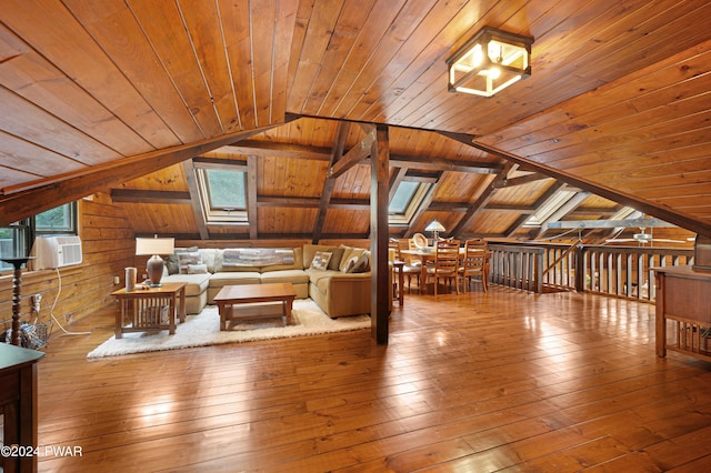 unfurnished living room with wooden walls, vaulted ceiling with skylight, and wooden ceiling