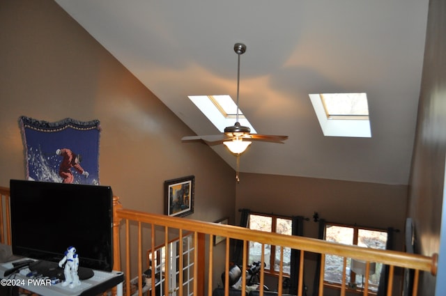 interior space featuring vaulted ceiling with skylight and ceiling fan